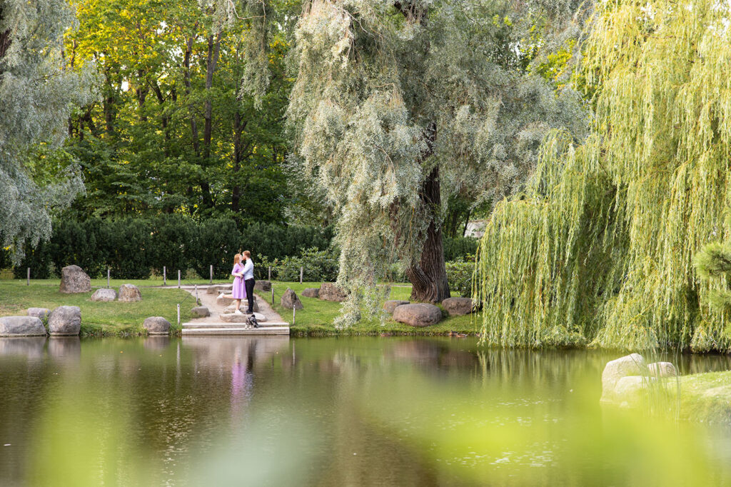 Scenic couple photo at a pond with lush nature